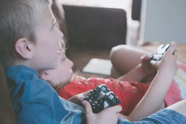 two boy and girl holding game controllers 1103563 1